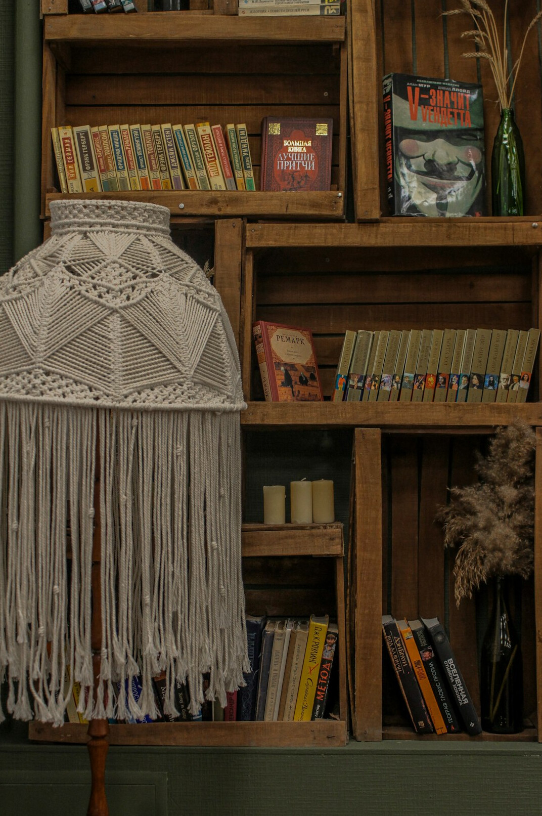 Library shelves full of books with a reading lamp